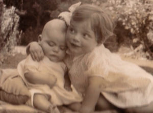 Rob and Carol Sinclair playing together as baby and toddler in 1940s